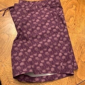 Mauve shorts with palm trees on it. Size XL